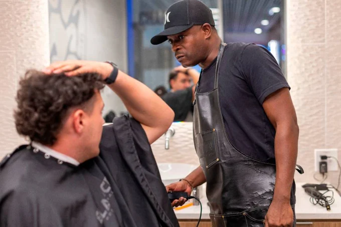 Barber working on a client at Custom Cuts by LP