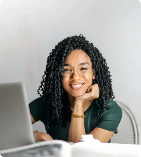 Woman-owned small business owner smiling at her laptop