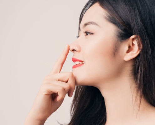 Oahu cheek fat removal surgeon in Honolulu examines patient before Oahu cheek reduction procedure, Hawaii.
