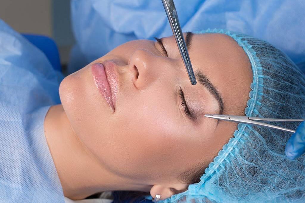 Licensed Hawaii plastic surgeon removes gauze after eyelid surgery, Oahu.