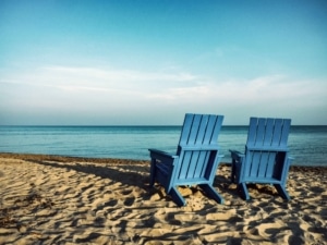 Two blue chairs on a beach in Hawaii