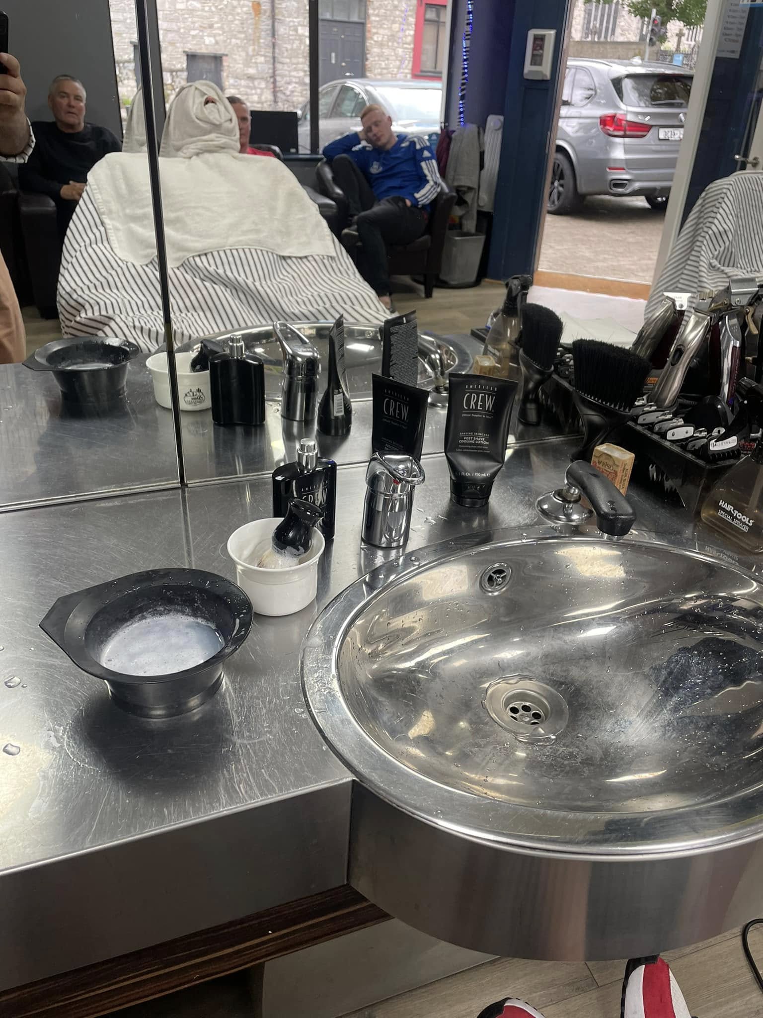 Barber working at a station inside the shop