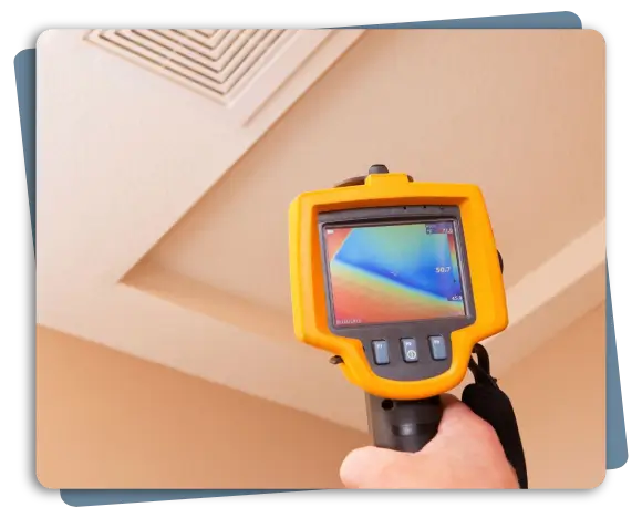 Weather Knight technician performing thermal imaging inspection on flat roof